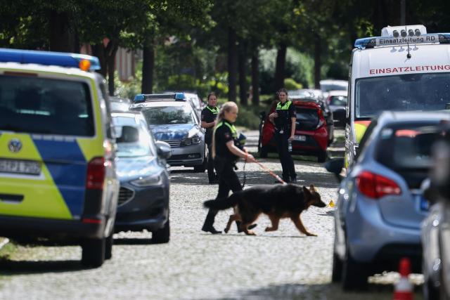 Police use a dog as they investigate near the scene where five people were killed in a shooting in Stade, northern Germany, a city some 50 kilometres west of Hamburg, on June 29, 2026. German police said five people were killed and others injured on June 29, 2026 in a shooting in a youth welfare facility in the northern city of Stade. Two people were arrested, including the suspected shooter, and there was now "no danger to the public", local police said in an update around 1215 GMT. (Photo by Ibrahim OT / AFP)