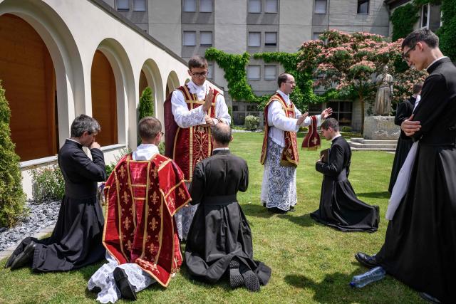 Priests receive blessings from newly ordained priests, after an ordination ceremony of the traditionalist Catholic Society of Saint Pius X (SSPX), in Econe, near Sion, western Switzerland, on June 29, 2026. Defying Vatican, Society of Saint Pius X will ordain its own bishops on July 1, 2026, despite the risk of being considered schismatic. (Photo by Fabrice COFFRINI / AFP)