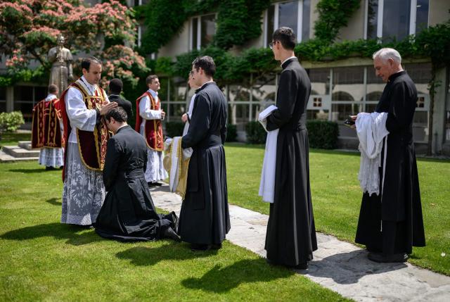 Priests receive blessings from a newly ordained priest, after an ordination ceremony of the traditionalist Catholic Society of Saint Pius X (SSPX), in Econe, near Sion, western Switzerland, on June 29, 2026. Defying Vatican, Society of Saint Pius X will ordain its own bishops on July 1, 2026, despite the risk of being considered schismatic. (Photo by Fabrice COFFRINI / AFP)