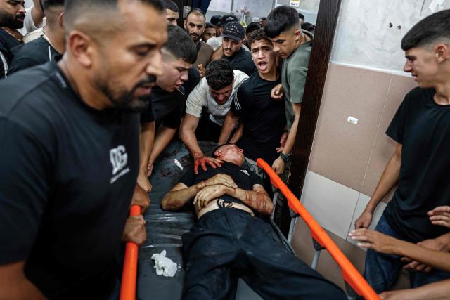 EDITORS NOTE: Graphic content / Mourners carry the body of Amir Ahmad Jawad Jaber, a Palestinian teenager who was killed during an Israeli raid, at a hospital in Ramallah, in the Israeli-occupied West Bank on June 29, 2026. Israeli forces fatally shot a 15-year-old Palestinian teenager during a raid in the occupied West Bank on June 29, the Palestinian health ministry said, as violence surges in the Israeli-occupied territory. (Photo by Zain JAAFAR / AFP)