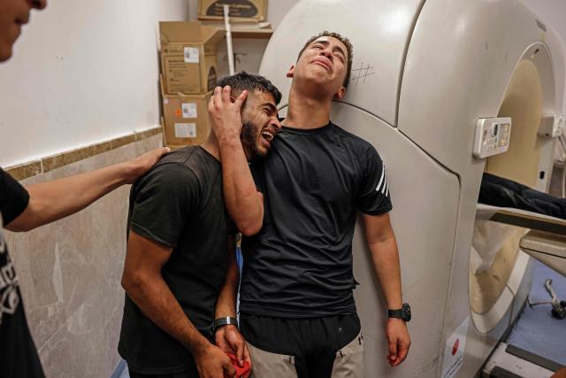 Relatives mourn the death of Amir Ahmad Jawad Jaber, a Palestinian teenager who was killed during an Israeli raid, at a hospital in Ramallah, in the Israeli-occupied West Bank on June 29, 2026. Israeli forces fatally shot a 15-year-old Palestinian teenager during a raid in the occupied West Bank on June 29, the Palestinian health ministry said, as violence surges in the Israeli-occupied territory. (Photo by Zain JAAFAR / AFP)