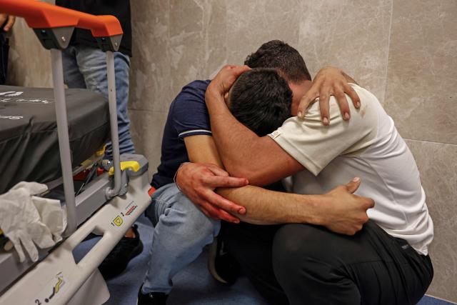 Relatives mourn the death of Amir Ahmad Jawad Jaber, a Palestinian teenager who was killed during an Israeli raid, at a hospital in Ramallah, in the Israeli-occupied West Bank on June 29, 2026. Israeli forces fatally shot a 15-year-old Palestinian teenager during a raid in the occupied West Bank on June 29, the Palestinian health ministry said, as violence surges in the Israeli-occupied territory. (Photo by Zain JAAFAR / AFP)