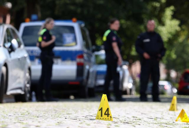 Police evidence markers are seen near the scene where five people were killed in a shooting in Stade, northern Germany, a city some 50 kilometres west of Hamburg, on June 29, 2026. German police said five people were killed and others injured on June 29, 2026 in a shooting in a youth welfare facility in the northern city of Stade. Two people were arrested, including the suspected shooter, and there was now "no danger to the public", local police said in an update around 1215 GMT. (Photo by Ibrahim OT / AFP)