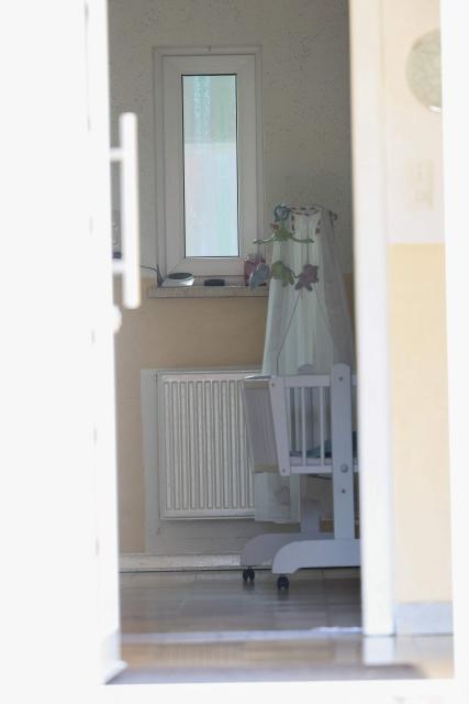 Picture taken on June 29, 2026 shows baby's bed seen thorugh the entrance of a youth centre where a shooting took place in Stade, northern Germany, a city some 50 kilometres west of Hamburg. German police said six people were killed and others injured on June 29, 2026 in a shooting in a youth welfare facility in the northern city of Stade. Two people were arrested, including the suspected shooter, and there was now "no danger to the public", local police said in an update around 1215 GMT. (Photo by Ibrahim OT / AFP)