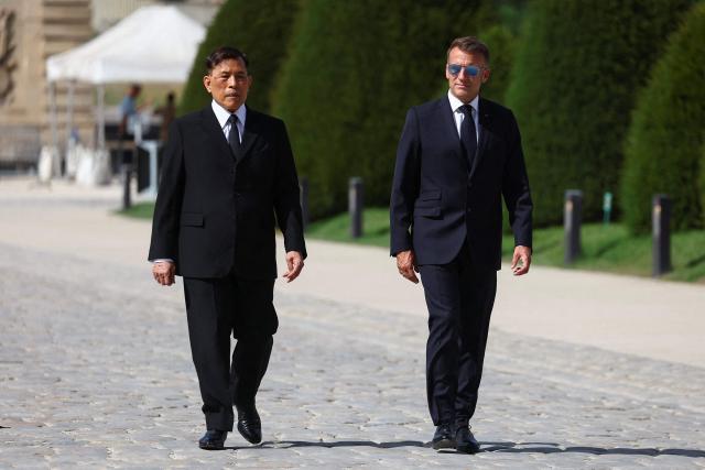 France's President Emmanuel Macron (R) walks with Thailand's King Maha Vajiralongkorn (L) during a welcoming ceremony in the courtyard of the Hotel des Invalides in Paris on June 29, 2026, as part of an official state visit of the Thai King to France. The King of Thailand is visiting France from June 28 to July 2, the first by a Thai monarch to France since 1960, marking the 170th anniversary of the establishment of diplomatic relations between the two countries. (Photo by Abdul Saboor / POOL / AFP)