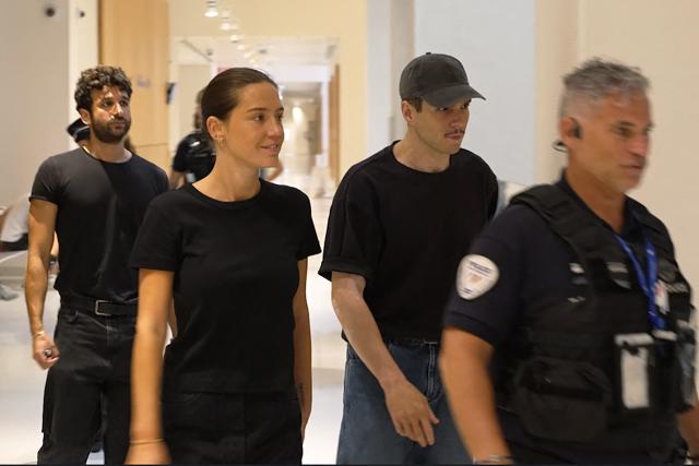 This screen grab taken from an AFP Video shows French actress Adele Exarchopoulos (2ndR) and her partner French actor Francois Civil (2ndR) walking in a corridor during a suspension of the hearing during the trial of Exarchopoulos' former partner, French rapper Doums (aka Mamadou Coulibaly) for domestic violence at the Paris Courthouse in Paris on June 29, 2026. (Photo by Benoît DUCROCQ / AFP)