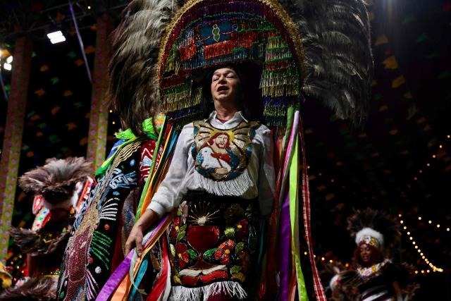 Members of a Batalhao (a dance and singing group) take part in a performance of the Bumba-Meu-Boi traditional festival, in Sao Luis, Maranhao State, northern Brazil, on June 25, 2026. Recognized by UNESCO as Intangible Cultural Heritage of Humanity, the Bumba-Meu-Boi festivities tell the legend of Pai Francisco and Mae Catirina, who sacrifice their employer’s favorite ox to fulfill the wish of his pregnant wife, culminating in the animal’s resurrection. (Photo by Antonello Veneri / AFP)