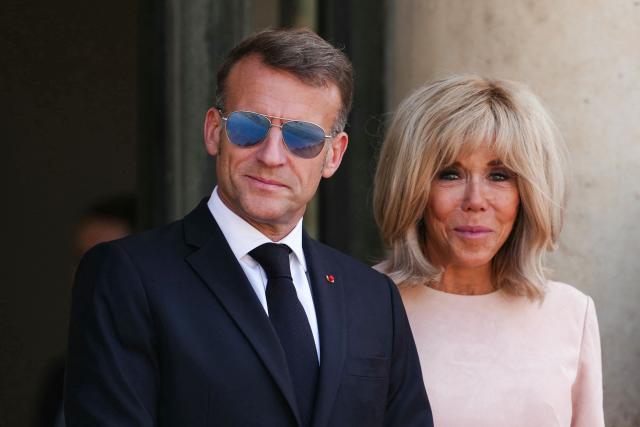 France's President Emmanuel Macron (L) and his wife Brigitte Macron wait to welcome Thailand's King ahead of a meeting at The Elysee Presidential Palace in Paris on June 29, 2026. (Photo by Dimitar DILKOFF / AFP)