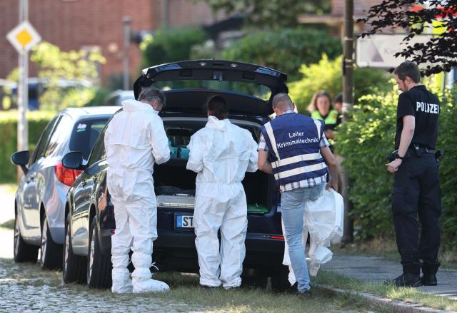 The head of forensic police puts on his protective suit to work at the scene where six people were killed in a shooting in Stade, northern Germany, a city some 50 kilometres west of Hamburg, on June 29, 2026. A sixth person has died after a shooting at a youth centre in northern Germany on June 29, 2026, according to police, who said that the deadly shooting likely stems from "an extended family tragedy". All six of those killed in the shooting are adults, and one further person injured in the shooting is being treated but is "stable," a police spokesman told AFP. A male suspected shooter has been arrested, and two other people are being held in police custody whose connection with the deadly shooting remains under investigation, according to police. (Photo by Ibrahim OT / AFP)