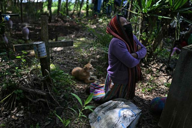 A woman attends the burial of a relative killed during the internal armed conflict (1960-1996), at a cemetery in Pacoj village, San Martin Jilotepeque, Guatemala on June 29, 2026. The remains of 68 people -- victims of the 36-year internal armed conflict -- were buried on June 29, 2026. According to the Commission for Historical Clarification, more than 200,000 people were killed or disappeared in the civil war. (Photo by JOHAN ORDONEZ / AFP)