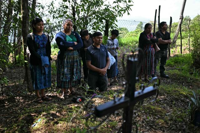 People attend the burial of relatives killed during the internal armed conflict (1960-1996), at a cemetery in Pacoj village, San Martin Jilotepeque, Guatemala on June 29, 2026. The remains of 68 people -- victims of the 36-year internal armed conflict -- were buried on June 29, 2026. According to the Commission for Historical Clarification, more than 200,000 people were killed or disappeared in the civil war. (Photo by JOHAN ORDONEZ / AFP)