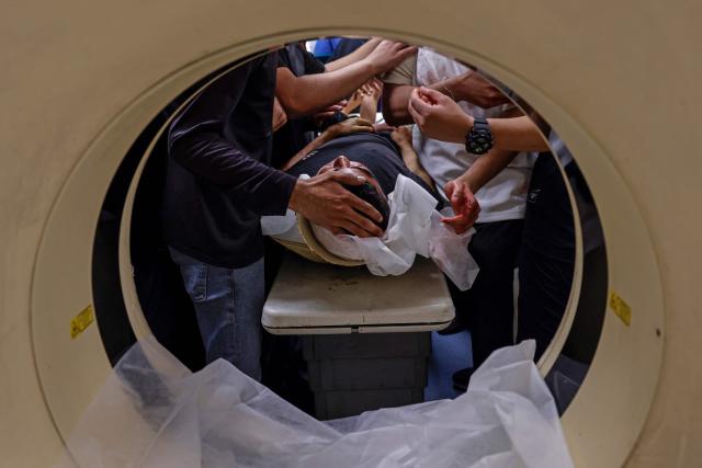 EDITORS NOTE: Graphic content / Mourners gather around the body of Amir Ahmad Jawad Jaber, a Palestinian teenager who was killed during an Israeli raid, at a hospital in Ramallah, in the Israeli-occupied West Bank on June 29, 2026. Israeli forces fatally shot a 15-year-old Palestinian teenager during a raid in the occupied West Bank on June 29, the Palestinian health ministry said, as violence surges in the Israeli-occupied territory. (Photo by Zain JAAFAR / AFP)