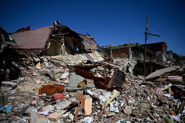 View of rubble in El Junquito, Venezuela on June 29, 2026, after twin earthquakes. Hopes were fading on June 29, 2026 of finding survivors more than four days after powerful twin earthquakes struck Venezuela, as residents grow increasingly frustrated with the government's response to the disaster that has killed at least 1,450 people and left tens of thousands unaccounted for. (Photo by Federico PARRA / AFP)