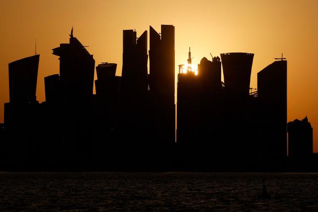 The sun sets behind the Doha skyline on June 29, 2026. (Photo by Karim JAAFAR / AFP)