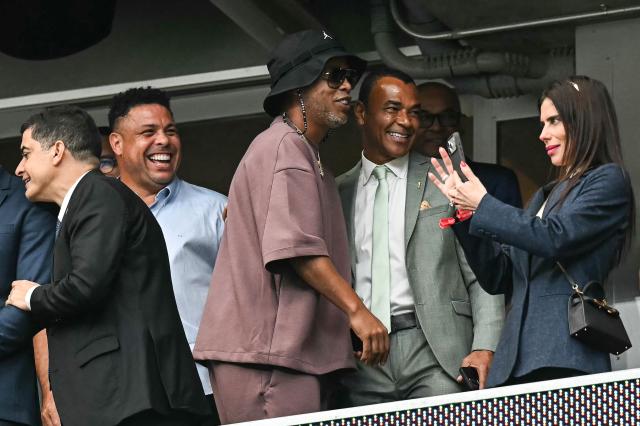 Brazilian former football players Ronaldo (2nd L), Ronaldinho (C) and Cafu (2nd R) react as they attend the 2026 World Cup round of 32 football match between Brazil and Japan at the Houston Stadium in Houston on June 29, 2026.  (Photo by Paul ELLIS / AFP)