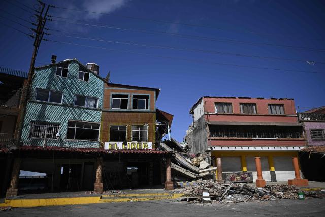 View of rubble in El Junquito, Venezuela on June 29, 2026, after twin earthquakes. Hopes were fading on June 29, 2026 of finding survivors more than four days after powerful twin earthquakes struck Venezuela, as residents grow increasingly frustrated with the government's response to the disaster that has killed at least 1,450 people and left tens of thousands unaccounted for. (Photo by Federico PARRA / AFP)