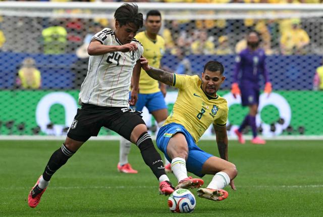 Japan's midfielder #24 Kaishu Sano (L) fights for the ball with Brazil's midfielder #08 Bruno Guimaraes (R) at the Houston Stadium in Houston on June 29, 2026. (Photo by RONALDO SCHEMIDT / AFP)
