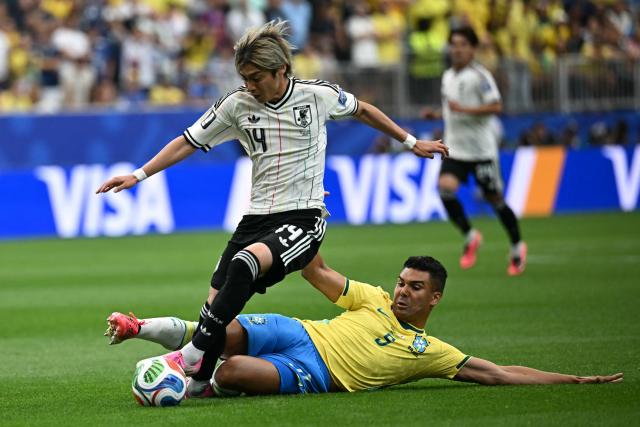 Brazil's midfielder #05 Casemiro (R) tackles and fouls Japan's midfielder #14 Junya Ito (L) leading to a yellow card during the 2026 World Cup round of 32 football match between Brazil and Japan at the Houston Stadium in Houston on June 29, 2026.  (Photo by Paul ELLIS / AFP)