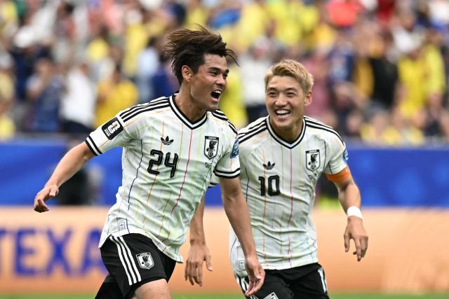 Japan's midfielder #24 Kaishu Sano (L) celebrates  after scoring the opening goal during the 2026 World Cup round of 32 football match between Brazil and Japan at the Houston Stadium in Houston on June 29, 2026.  (Photo by Paul ELLIS / AFP)