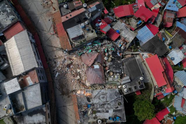 Aerial view of El Junquito, Venezuela on June 29, 2026, after twin earthquakes. Hopes were fading on June 29, 2026 of finding survivors more than four days after powerful twin earthquakes struck Venezuela, as residents grow increasingly frustrated with the government's response to the disaster that has killed at least 1,450 people and left tens of thousands unaccounted for. (Photo by Federico PARRA / AFP)