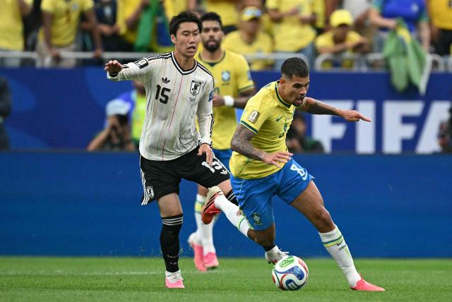 Japan's midfielder #15 Daichi Kamada (L) fights for the ball with Brazil's midfielder #08 Bruno Guimaraes during the 2026 World Cup round of 32 football match between Brazil and Japan at the Houston Stadium in Houston on June 29, 2026.  (Photo by RONALDO SCHEMIDT / AFP)