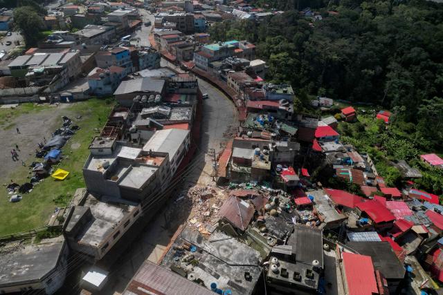 Aerial view of El Junquito, Venezuela on June 29, 2026, after twin earthquakes. Hopes were fading on June 29, 2026 of finding survivors more than four days after powerful twin earthquakes struck Venezuela, as residents grow increasingly frustrated with the government's response to the disaster that has killed at least 1,450 people and left tens of thousands unaccounted for. (Photo by Federico PARRA / AFP)