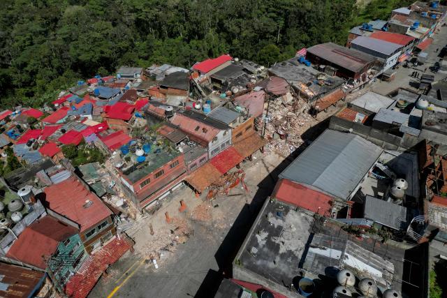 Aerial view of El Junquito, Venezuela on June 29, 2026, after twin earthquakes. Hopes were fading on June 29, 2026 of finding survivors more than four days after powerful twin earthquakes struck Venezuela, as residents grow increasingly frustrated with the government's response to the disaster that has killed at least 1,450 people and left tens of thousands unaccounted for. (Photo by Federico PARRA / AFP)