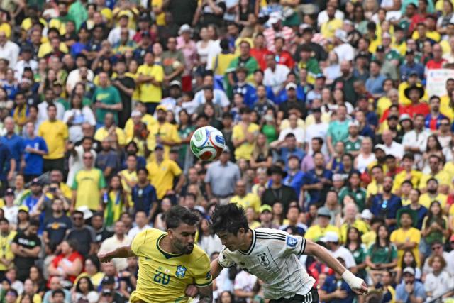 Brazil's midfielder #20 Lucas Paqueta (L) fights for the ball with Japan's defender #03 Shogo Taniguchi during the 2026 World Cup round of 32 football match between Brazil and Japan at the Houston Stadium in Houston on June 29, 2026.  (Photo by RONALDO SCHEMIDT / AFP)
