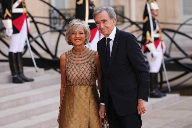 French-Canadian pianist Helene Mercier-Arnault (L) and Member of the Academie des sciences morales et politiques (France's ethics and political sciences academy) Bernard Arnault (R) arrive at The Elysee Presidential Palace for a working dinner with France's President and Thailand's King Maha Vajiralongkorn as part of the Thai King's State visit to France, in Paris on June 29, 2026.  (Photo by Dimitar DILKOFF / AFP)