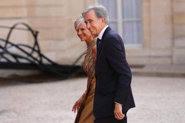French-Canadian pianist Helene Mercier-Arnault (L) and Member of the Academie des sciences morales et politiques (France's ethics and political sciences academy) Bernard Arnault (R) arrive at The Elysee Presidential Palace for a working dinner with France's President and Thailand's King Maha Vajiralongkorn as part of the Thai King's State visit to France, in Paris on June 29, 2026.  (Photo by Dimitar DILKOFF / AFP)