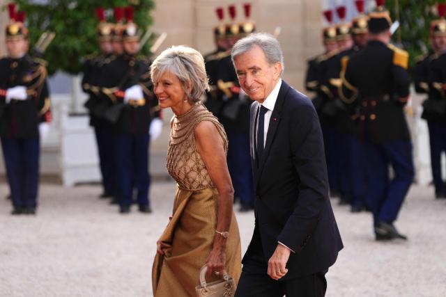 French-Canadian pianist Helene Mercier-Arnault (L) and Member of the Academie des sciences morales et politiques (France's ethics and political sciences academy) Bernard Arnault (R) arrive at The Elysee Presidential Palace for a working dinner with France's President and Thailand's King Maha Vajiralongkorn as part of the Thai King's State visit to France, in Paris on June 29, 2026.  (Photo by Dimitar DILKOFF / AFP)
