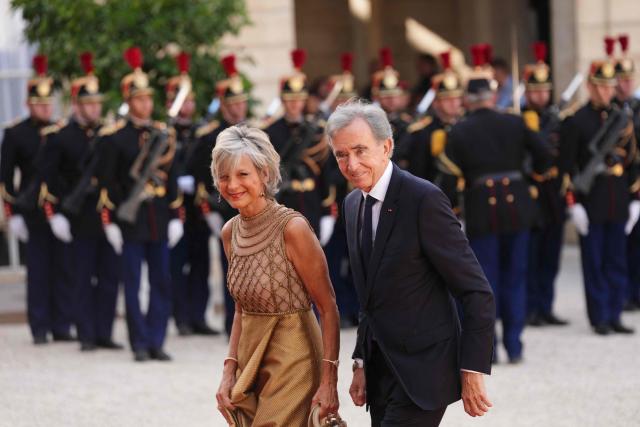 French-Canadian pianist Helene Mercier-Arnault (L) and Member of the Academie des sciences morales et politiques (France's ethics and political sciences academy) Bernard Arnault (R) arrive at The Elysee Presidential Palace for a working dinner with France's President and Thailand's King Maha Vajiralongkorn as part of the Thai King's State visit to France, in Paris on June 29, 2026.  (Photo by Dimitar DILKOFF / AFP)