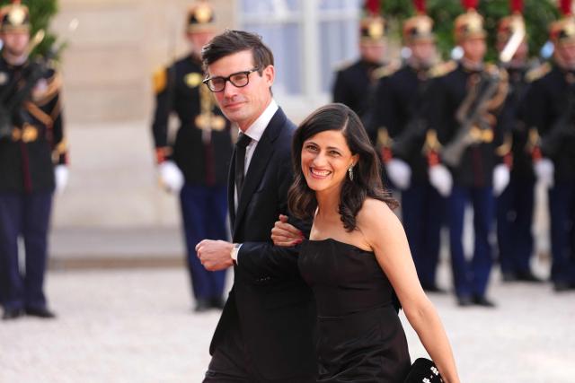 France’s junior Minister in charge of global Francophones and expatriates Eleonore Caroit (R) and her partner Roman Pinosch (L) arrive at The Elysee Presidential Palace for a working dinner with France's President and Thailand's King Maha Vajiralongkorn as part of the Thai King's State visit to France, in Paris on June 29, 2026.  (Photo by Dimitar DILKOFF / AFP)