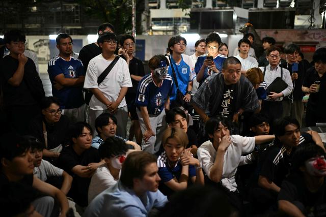 Fans watch the 2026 World Cup Group F football match between Japan and Brazil in Tokyo's Shibuya district early on June 30, 2026. (Photo by Philip FONG / AFP)