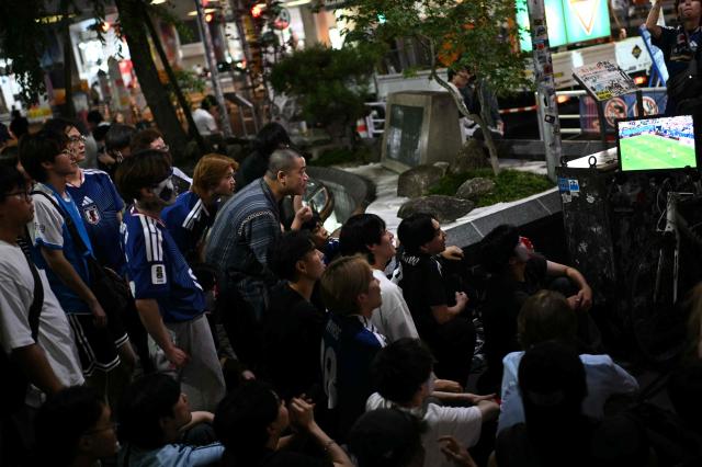 Fans watch the 2026 World Cup Group F football match between Japan and Brazil in Tokyo's Shibuya district early on June 30, 2026. (Photo by Philip FONG / AFP)