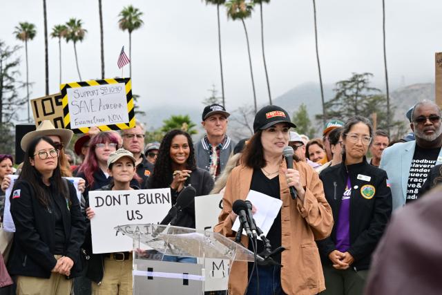 Altadena resident Kara Vallow speaks to survivors of the 2025 Eaton Fire during a demonstration in Altadena, California, on June 29, 2026. Altadena residents are expressing support of California Senate Bill SB 1090, which addresses disaster recovery, restricting rapid large-scale investor purchases and exemptions in fire-damaged areas from dense housing laws, allowing for local residents to rebuild without having coprporate buyers displace them. (Photo by Frederic J. BROWN / AFP)