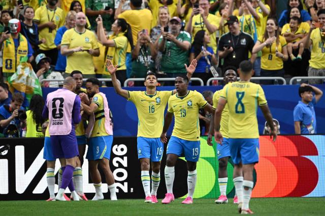 Brazil's defender #16 Douglas Santos (C) celebrates his team's second goal during the 2026 World Cup round of 32 football match between Brazil and Japan at the Houston Stadium in Houston on June 29, 2026.  (Photo by RONALDO SCHEMIDT / AFP)