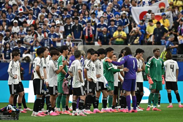 Japan's players react after losing the 2026 World Cup round of 32 football match between Brazil and Japan at the Houston Stadium in Houston on June 29, 2026.  (Photo by Paul ELLIS / AFP)