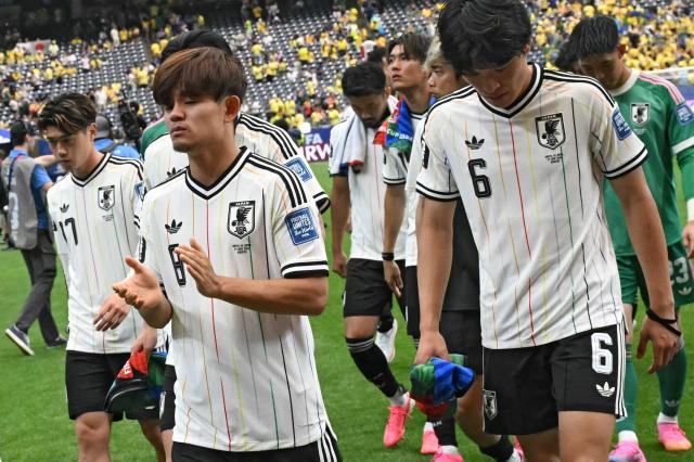 Japan's midfielder #08 Takefusa Kubo (front, L) and Japan's forward #06 Shuto Machino react at the end of the 2026 World Cup round of 32 football match between Brazil and Japan at the Houston Stadium in Houston on June 29, 2026.  (Photo by RONALDO SCHEMIDT / AFP)