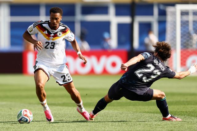 Germany's defender #23 Felix Nmecha (L) and Paraguay's midfielder #23 Matias Galarza (R) fight for the ball during the 2026 World Cup round of 32 football match between Germany and Paraguay at the Boston Stadium in Foxborough on June 29, 2026.  (Photo by CHARLY TRIBALLEAU / AFP)