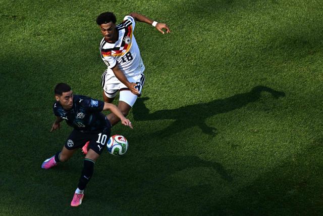 Paraguay's midfielder #10 Miguel Almiron and Germany's defender #18 Nathaniel Brown fight for the ball during the 2026 World Cup round of 32 football match between Germany and Paraguay at the Boston Stadium in Foxborough on June 29, 2026.  (Photo by Jewel SAMAD / AFP)