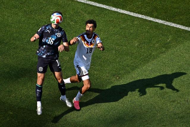 Paraguay's midfielder #16 Damian Bobadilla heads the ball past Germany's defender #18 Nathaniel Brown during the 2026 World Cup round of 32 football match between Germany and Paraguay at the Boston Stadium in Foxborough on June 29, 2026.  (Photo by Jewel SAMAD / AFP)