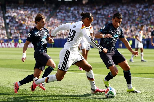 (L-R) Paraguay's midfielder #23 Matias Galarza, Germany's forward #19 Leroy Sane, and Paraguay's defender #06 Junior Alonso fight for the ball during the 2026 World Cup round of 32 football match between Germany and Paraguay at the Boston Stadium in Foxborough on June 29, 2026.  (Photo by CHARLY TRIBALLEAU / AFP)