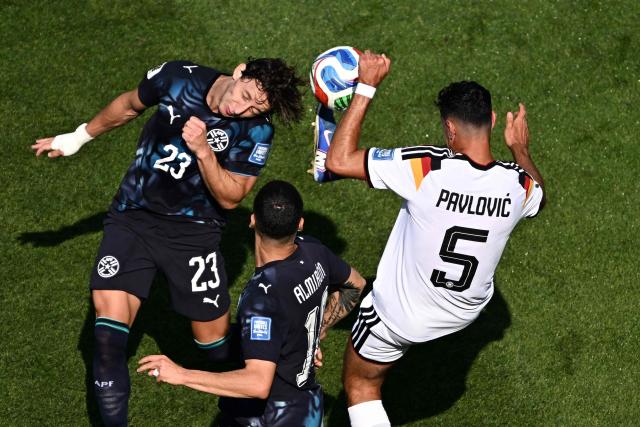 Paraguay's midfielder #23 Matias Galarza and Germany's defender #05 Aleksandar Pavlovic fight for the ball during the 2026 World Cup round of 32 football match between Germany and Paraguay at the Boston Stadium in Foxborough on June 29, 2026.  (Photo by Jewel SAMAD / AFP)