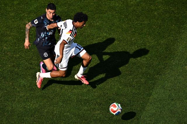 Paraguay's midfielder #10 Miguel Almiron and Germany's defender #18 Nathaniel Brown fight for the ball during the 2026 World Cup round of 32 football match between Germany and Paraguay at the Boston Stadium in Foxborough on June 29, 2026.  (Photo by Jewel SAMAD / AFP)