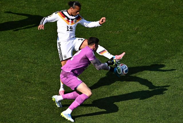 Paraguay's goalkeeper #12 Orlando Gill (R) makes a save past Germany's forward #19 Leroy Sane during the 2026 World Cup round of 32 football match between Germany and Paraguay at the Boston Stadium in Foxborough on June 29, 2026.  (Photo by Jewel SAMAD / AFP)
