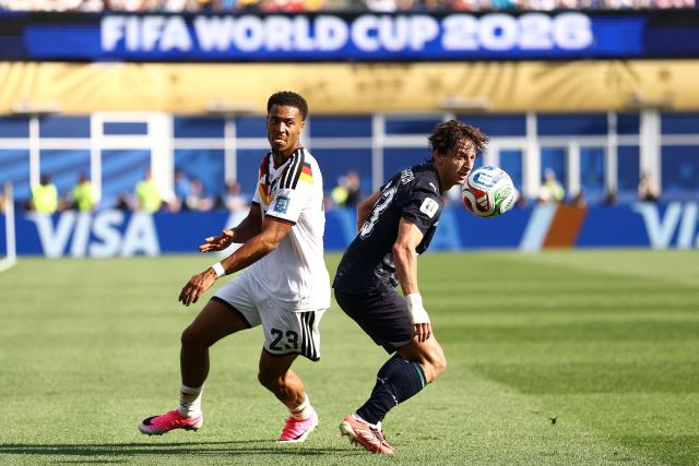 Germany's defender #23 Felix Nmecha (L) and Paraguay's midfielder #23 Matias Galarza (R) fight for the ball during the 2026 World Cup round of 32 football match between Germany and Paraguay at the Boston Stadium in Foxborough on June 29, 2026.  (Photo by CHARLY TRIBALLEAU / AFP)