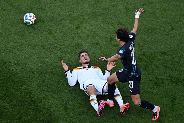 Germany's forward #07 Kai Havertz (L) falls on the ground past Paraguay's midfielder #23 Matias Galarza during the 2026 World Cup round of 32 football match between Germany and Paraguay at the Boston Stadium in Foxborough on June 29, 2026.  (Photo by Jewel SAMAD / AFP)