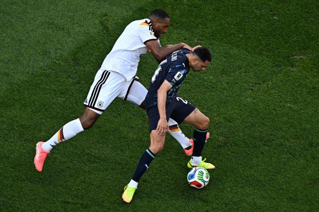 Germany's defender #04 Jonathan Tah (L) and Paraguay's forward #24 Gustavo Caballero (R) fight for the ball during the 2026 World Cup round of 32 football match between Germany and Paraguay at the Boston Stadium in Foxborough on June 29, 2026.  (Photo by Jewel SAMAD / AFP)