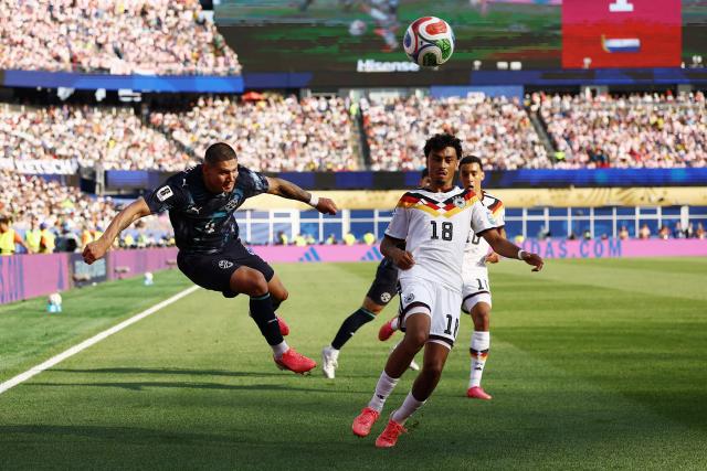 Paraguay's defender #04 Juan Jose Caceres and Germany's defender #18 Nathaniel Brown fight for the ball during the 2026 World Cup round of 32 football match between Germany and Paraguay at the Boston Stadium in Foxborough on June 29, 2026.  (Photo by CHARLY TRIBALLEAU / AFP)